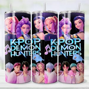 May include: Three stainless steel tumblers with a K-Pop theme. Each tumbler features a black background with the words "K-Pop Demon Hunters" and illustrations of animated characters. The tumblers have a straw and a lid.