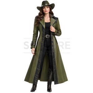 May include: A long olive green coat with black leather-like trim, a wide collar, and metallic buttons. The coat is worn with a matching olive green cowboy hat featuring a decorative band, a black top, black trousers, and black western-style boots.