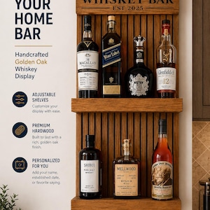 May include: A wall-mounted golden oak wooden whiskey bar shelf featuring two horizontal tiers for bottle storage. The top header is engraved with the text The Johnson's WHISKEY BAR EST 2025. The unit has a vertical slat back design.