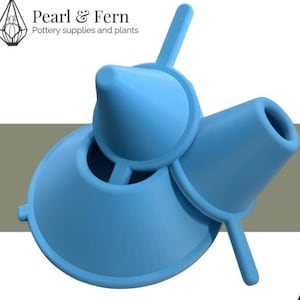 May include: A light blue pottery tool with a funnel shape and two handles. The image includes the text "Zero Trim" and "Now in all your favourite sizes". The product launch is from Pearl & Fern.