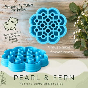 May include: A bright blue flower-shaped pottery tool with a grid of circular openings for arranging stems. The tool features a scalloped edge and a raised structure. Text on the image includes Designed by Potters For Potters, Functional Art for Everyday Beauty, A must-have for flower lovers, and the brand name PEARL & FERN POTTERY SUPPLIES & STUDIOS.