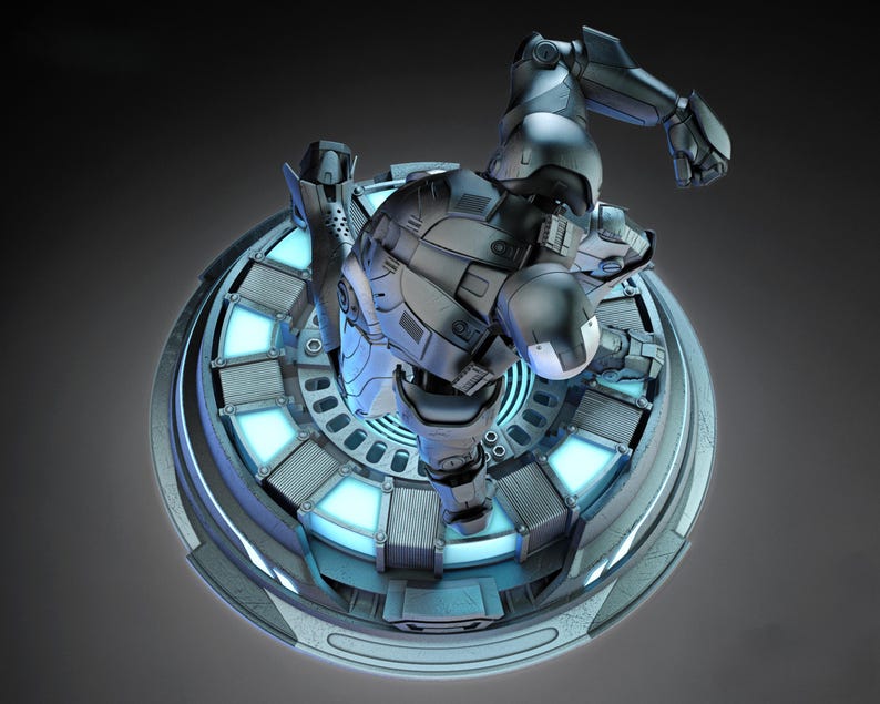 May include: A detailed, gray and black action figure of a superhero in a dynamic pose, mounted on a circular platform with glowing blue accents. The figure is highly detailed, with a metallic finish.