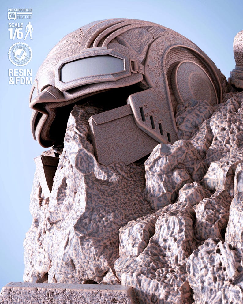 May include: A detailed, brown, futuristic helmet with a visor and intricate design, resting on a rocky surface. The image includes text indicating it is presupported, tested, and made with resin and FDM, at a 1/6 scale.
