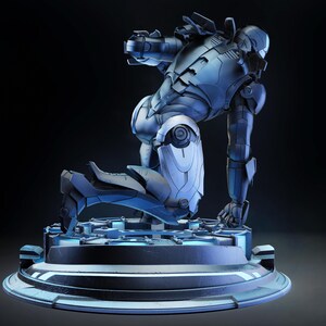 May include: A detailed, metallic blue and silver Iron Man action figure in a kneeling pose. The figure is on a circular, futuristic-looking base with blue lighting. The overall design suggests a high-tech, superhero theme.