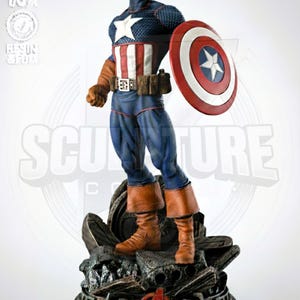 May include: A Captain America figurine in a dynamic pose, holding his iconic shield. The figure is clad in a blue, white, and red costume, with brown boots and gloves. The base features the Avengers logo.