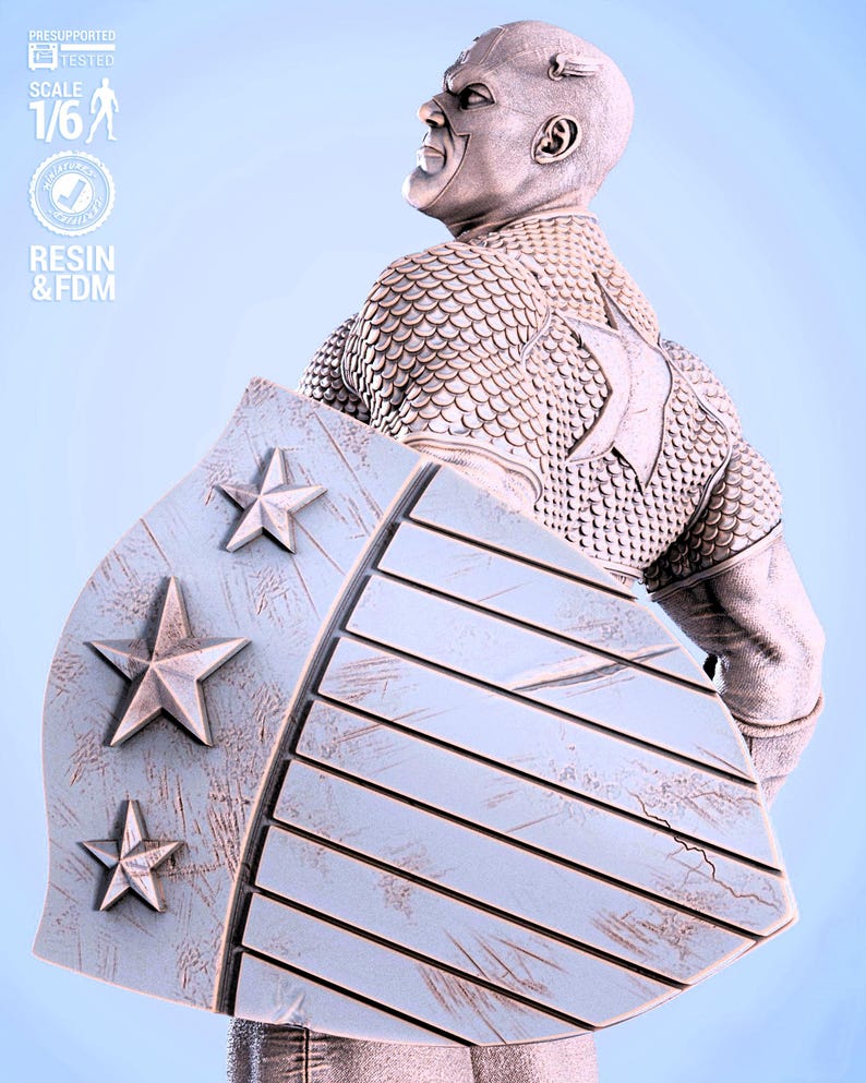 May include: A detailed statue of a superhero figure, holding a shield with star emblems. The figure is clad in a textured, scale-like armor. The shield has a wooden plank design. The statue is labeled "SCALE 1/6" and "RESIN & FDM".