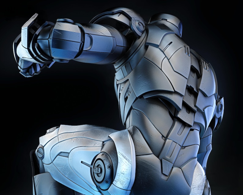 May include: A detailed, metallic silver and blue armored suit, possibly a superhero costume, is depicted against a dark background. The suit features segmented plates, intricate detailing, and a dynamic pose suggesting action. The lighting highlights the textures and contours.