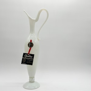 May include: White opaline glass pitcher with a handle and a label that reads "Opaline,  Chrétien de Sèvres".