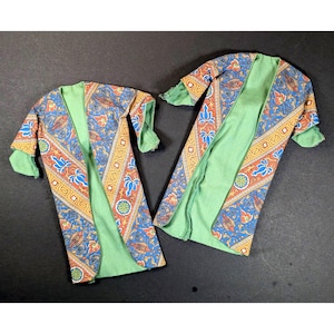 May include: A white ceramic mug with a black handle and the text "But First, Coffee" in a bold, black font. The mug is set against a neutral background, highlighting its simple design.