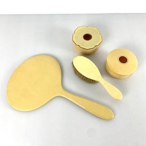 Vintage 4pc Art Deco Celluloid dresser set with hair receiver, brush and hand mirror