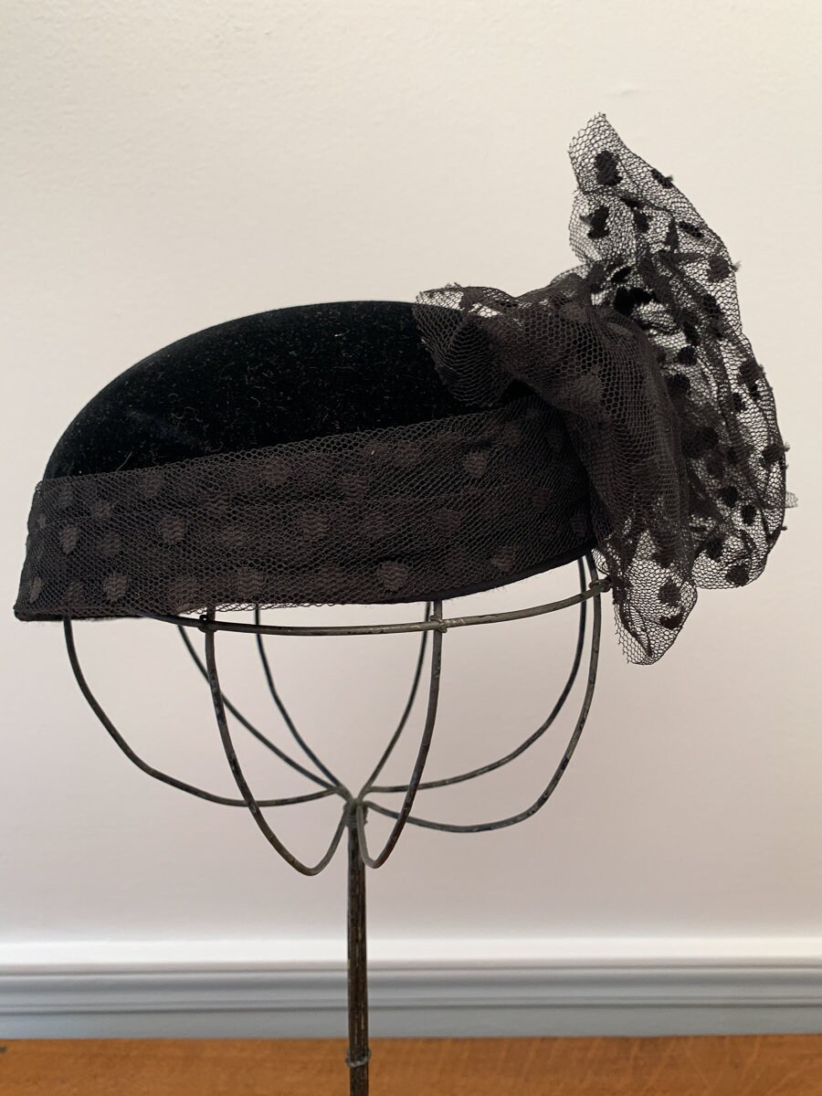 Vintage 1950s black pillbox hat with elaborate net bow and rhinestones