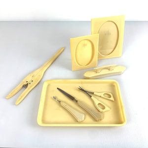 Vintage 8pc Art Deco Celluloid dresser set with glove stretcher, frames, scissors and nail buffer