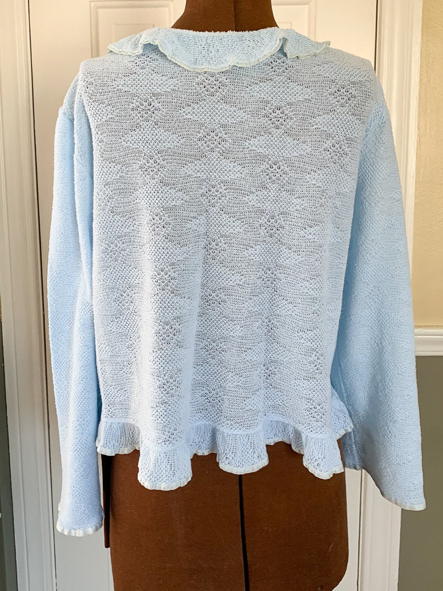 Vintage 1960s knit light blue bed jacket with ruffle and ribbon trim