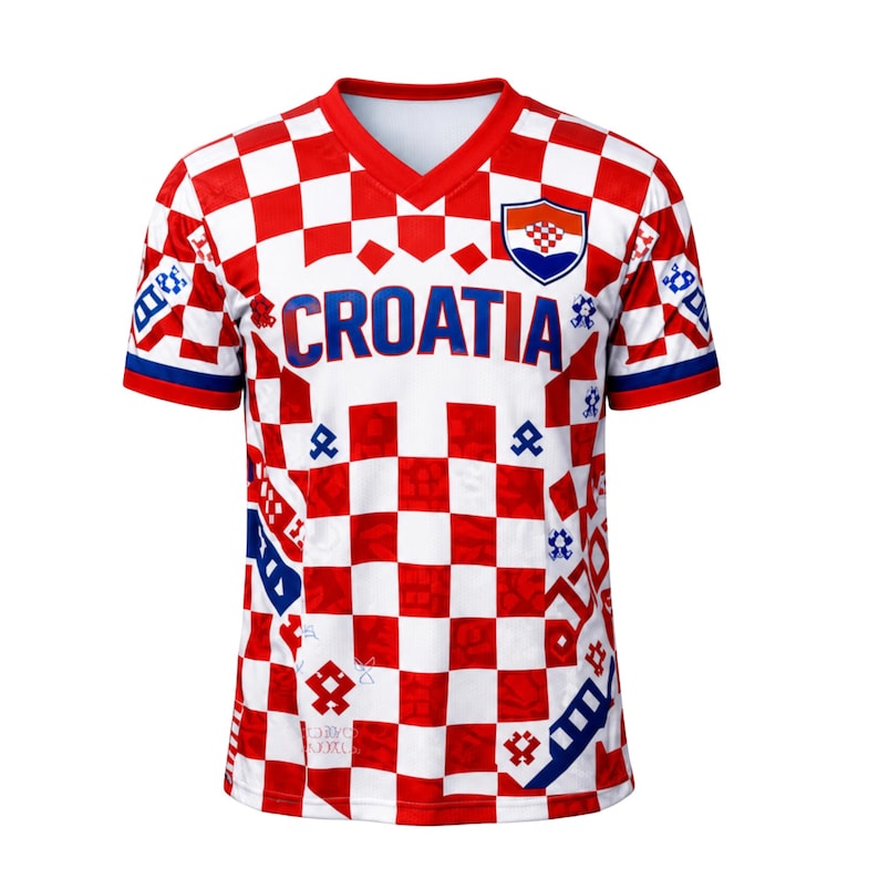 May include: A Croatia soccer jersey with a red and white checkered pattern. The jersey has a V-neck collar and the word "CROATIA" in blue across the chest. The Croatian coat of arms is on the upper right chest.