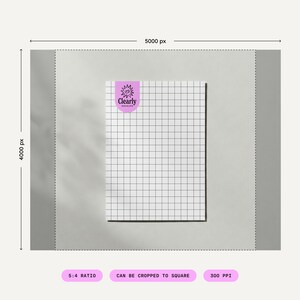 May include: A white grid paper with a black grid pattern and a purple sticker in the upper left corner. The sticker has the text "Clearly Mockups" in white. The paper is on a light grey background.