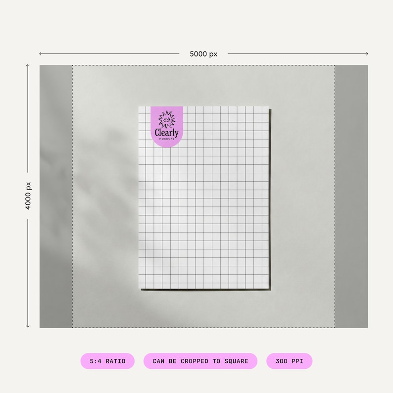May include: A white grid paper with a black grid pattern and a purple sticker in the upper left corner. The sticker has the text "Clearly Mockups" in white. The paper is on a light grey background.