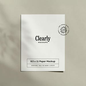 May include: A white 8.5 x 11 inch paper mockup with the text "Clearly MOCKUPS". The mockup includes the text "8.5 x 11 Paper Mockup" and "INTENTIONAL TOOLS FOR MAKERS & ARTISTS". A small graphic with the text "TURN SHADOW ON/OFF CHANGE BACKGROUND COLOR" is also present.