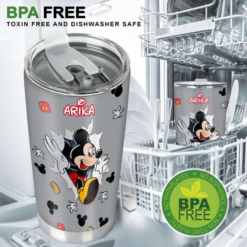 May include: A grey stainless steel travel mug with a Mickey Mouse graphic breaking through a wall. The mug has the word "ARIKA" in red and is labelled "BPA FREE, Toxin Free and Dishwasher Safe". The mug is in a dishwasher.