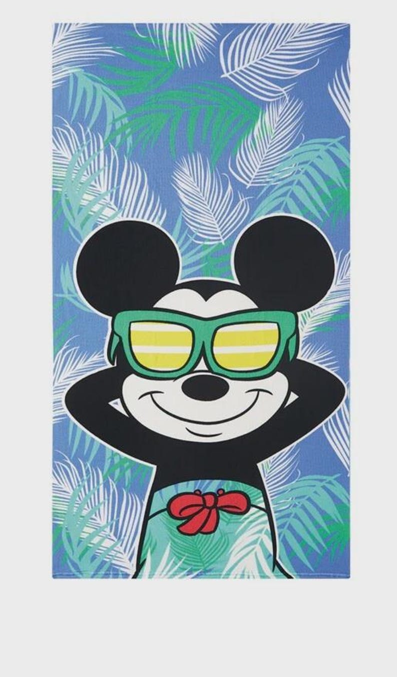 May include: Beach towel featuring Mickey Mouse wearing green sunglasses and a red bow tie. The background is a blue and green tropical leaf pattern. The towel is rectangular.