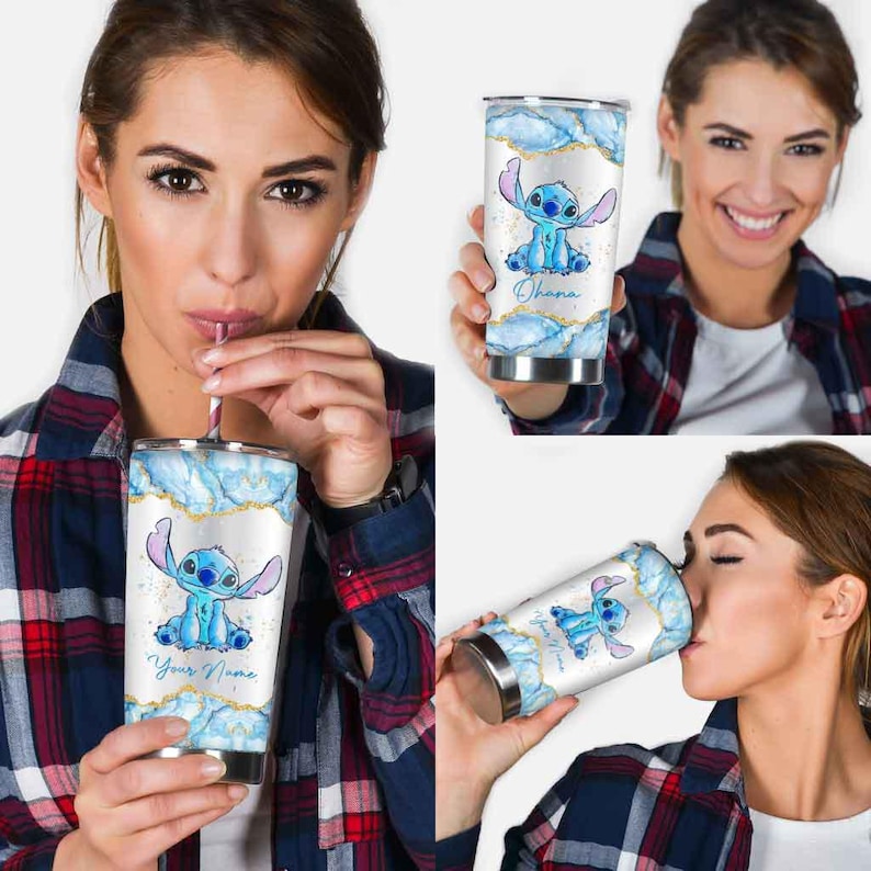 May include: A stainless steel tumbler featuring a blue cartoon character design. The tumbler has a white background with blue and gold accents. The text "Your Name" is printed on the tumbler.