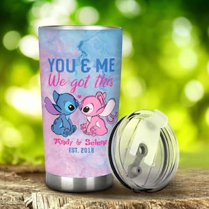 K&ouml;nnte beinhalten: Ein Edelstahlbecher mit Deckel. Der Becher hat ein blaues und rosa Marmormuster mit dem Text "YOU & ME We got this". Er hat auch Zeichentrickfiguren und die Namen "Andy & Selena" mit dem Jahr "EST. 2018".