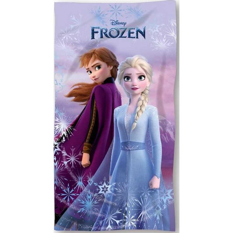 K&ouml;nnte beinhalten: Ein Strandtuch im Disney Frozen-Design mit Anna und Elsa. Das Handtuch hat einen hellvioletten Hintergrund mit Schneeflockenmustern und dem Disney Frozen-Logo. Elsa tr&auml;gt ein blaues Kleid und Anna einen lila Umhang.