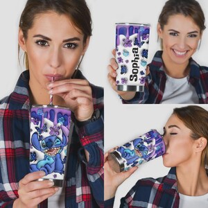 May include: A white stainless steel tumbler featuring a cartoon character, purple butterflies, and the name "Sophia". The tumbler has a purple dripping design at the top and is being held by a person.