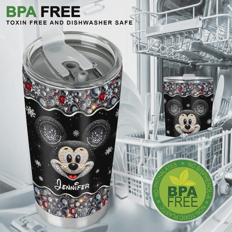May include: Black tumbler featuring a sparkling Mickey Mouse design with the name "Jennifer". The tumbler has a decorative border with red and silver gems. The text "BPA FREE" and "TOXIN FREE AND DISHWASHER SAFE" are visible.