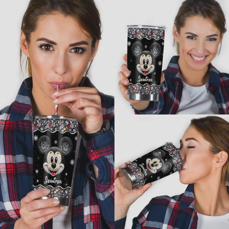 May include: A black stainless steel tumbler featuring a Mickey Mouse design with the name "Jennifer" in a cursive font. The tumbler has a decorative border with red, silver, and white accents. The design includes snowflakes.