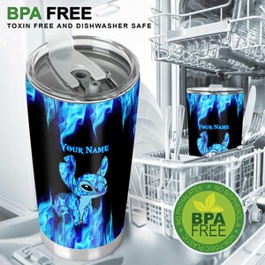 May include: A stainless steel tumbler with a black background and blue flame design. The tumbler features a cartoon character and the text "YOUR NAME". The tumbler is BPA free, toxin free, and dishwasher safe.