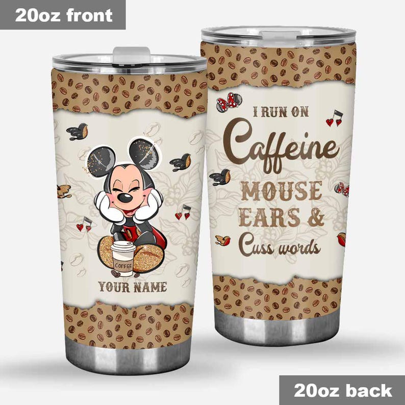 May include: A 20oz stainless steel tumbler with a lid. The front features a cartoon mouse character with the text "YOUR NAME" and "COFFEE". The back says "I RUN ON Caffeine MOUSE EARS & Cuss words". The top and bottom have a coffee bean design.
