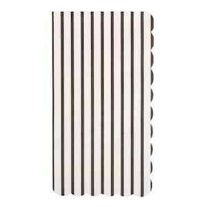 May include: A rectangular, folded napkin with a black and white striped pattern. The right edge has a scalloped design. The napkin is made of a soft, possibly paper, material.