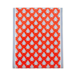May include: A folded red and white patterned textile with a blue and white floral design. The textile has a blue and white striped border on the left and right sides. The textile is likely a kitchen towel or decorative cloth.