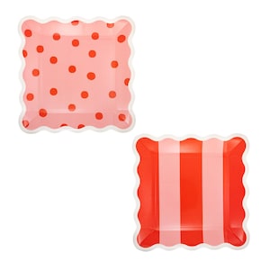 May include: Two square paper plates with scalloped edges. One plate has a pink background with red polka dots. The other plate has red and pink vertical stripes. Both plates have white scalloped edges.