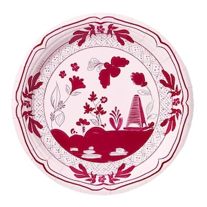 May include: A round, disposable paper plate with a white background and a burgundy floral design. The plate features a scalloped edge and a central illustration of flowers and a stylized building.