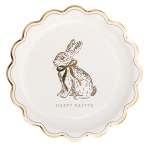 May include: White paper plate with a scalloped edge and gold trim. A gold illustration of a rabbit with a bow is centered on the plate, with the words "HAPPY EASTER" below.