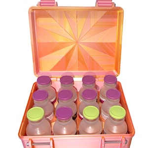 May include: A pink, open case with a geometric design on the lid, holding twelve small bottles. The bottles have clear bodies and are capped with purple and green lids. The case has a latch closure.