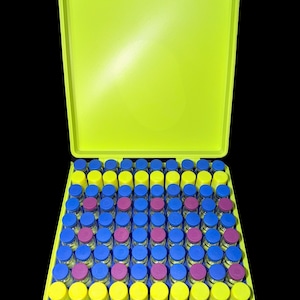 May include: A bright yellow case with a blue handle and clasp, open to reveal rows of small glass vials. The vials have blue, yellow, and magenta caps, neatly arranged inside the case. The background is black.
