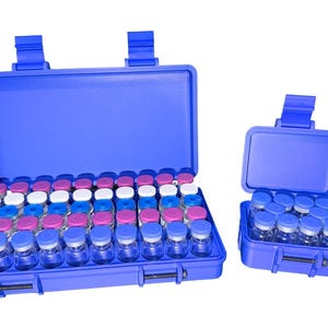May include: Two blue plastic cases, one open and one closed, filled with small glass vials. The open case contains rows of vials with colorful caps in blue, pink, and white. The smaller case holds a similar arrangement.