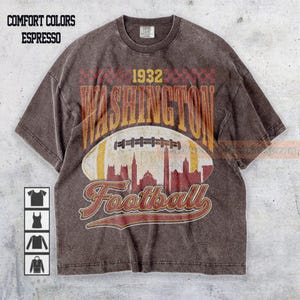 May include: Espresso-coloured t-shirt with a distressed graphic design. The design features the word "WASHINGTON" above a football illustration, with "1932" and "Football" in a vintage font. The shirt has a crew neck and short sleeves.