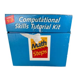 May include: A blue box labeled "Computational Skills Tutorial Kit" with "Levels 1-2" in a red box. The box also features the "Math Steps" logo in yellow, red, and white.