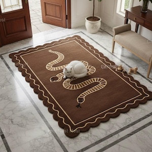 May include: A brown rectangular rug with a cream snake design and a scalloped edge. A white cat rests on the rug. The rug is on a marble floor. The rug's dimensions are in centimeters.