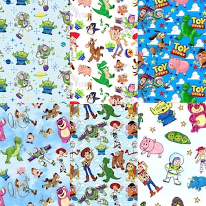 May include: A collage of six fabric patterns featuring Toy Story characters including Woody, Buzz Lightyear, Rex, Slinky Dog, Hamm, and the Aliens. The designs include various blue, white, and patterned backgrounds with stars, clouds, and logos.