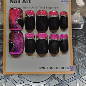 May include: A set of square-shaped false nails with a black base and a vibrant pink and silver glitter design. The nails are arranged on a card with the text "Nail Art" and "Nail Your Style - Art at Your Fingertips!" and size options.