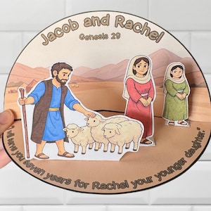 May include: A paper cutout depicting a scene from Genesis 29, featuring Jacob, Rachel, and sheep. The text "Jacob and Rachel" and "Genesis 29" are visible. The quote "I will serve you seven years for Rachel your younger daughter" is also present.