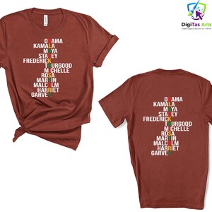 May include: A maroon t-shirt displaying a list of names in white, with green, yellow, and red accents. The names include Obama, Kamala, Maya, and others. The shirt has a crew neck and short sleeves.
