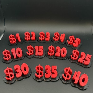May include: A collection of red 3D-printed dollar signs with values ranging from $1 to $40. Each number is on a black base. The numbers are in a bold, easy-to-read font, perfect for display or organization.