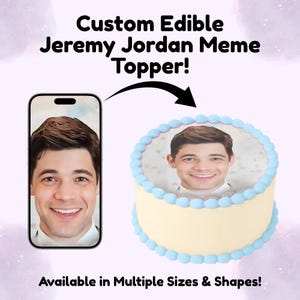 May include: A custom edible cake topper featuring a photograph of Jeremy Jordan. The image shows a smartphone displaying the same photo, with an arrow pointing to the round cake decorated with light blue frosting borders and the photo on top.