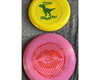 Wham-O Frisbee Lot 2 Pro Classic Lips & Dinosaur Grrrrr Flying Discs Two Sizes