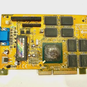 May include: A vintage yellow and black computer graphics card featuring multiple chips, connectors, and the text "3D AGP Phantom Series BIOS." It includes a blue VGA port and the date "N1996" printed on the card.